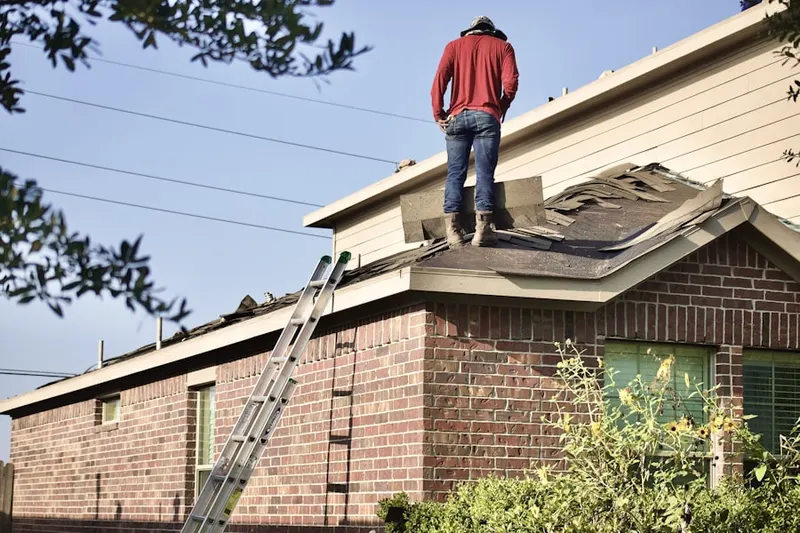 Professional roofer working on a residential roof in Alberhill District